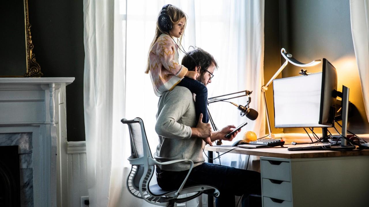 GettyImages-1350791754-father-working-in-home-office-with-daughter-on-shoulders